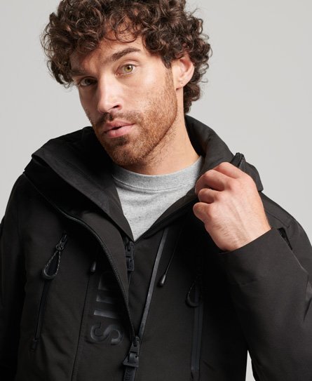 Hombre – Chaqueta cortavientos SD Ultimate en Negro Azabache/naranja  Intenso Superdry ES